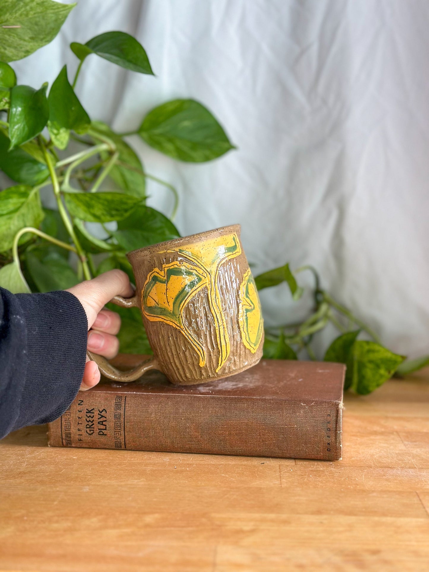 hand carved brown mug with ginkgo leaves