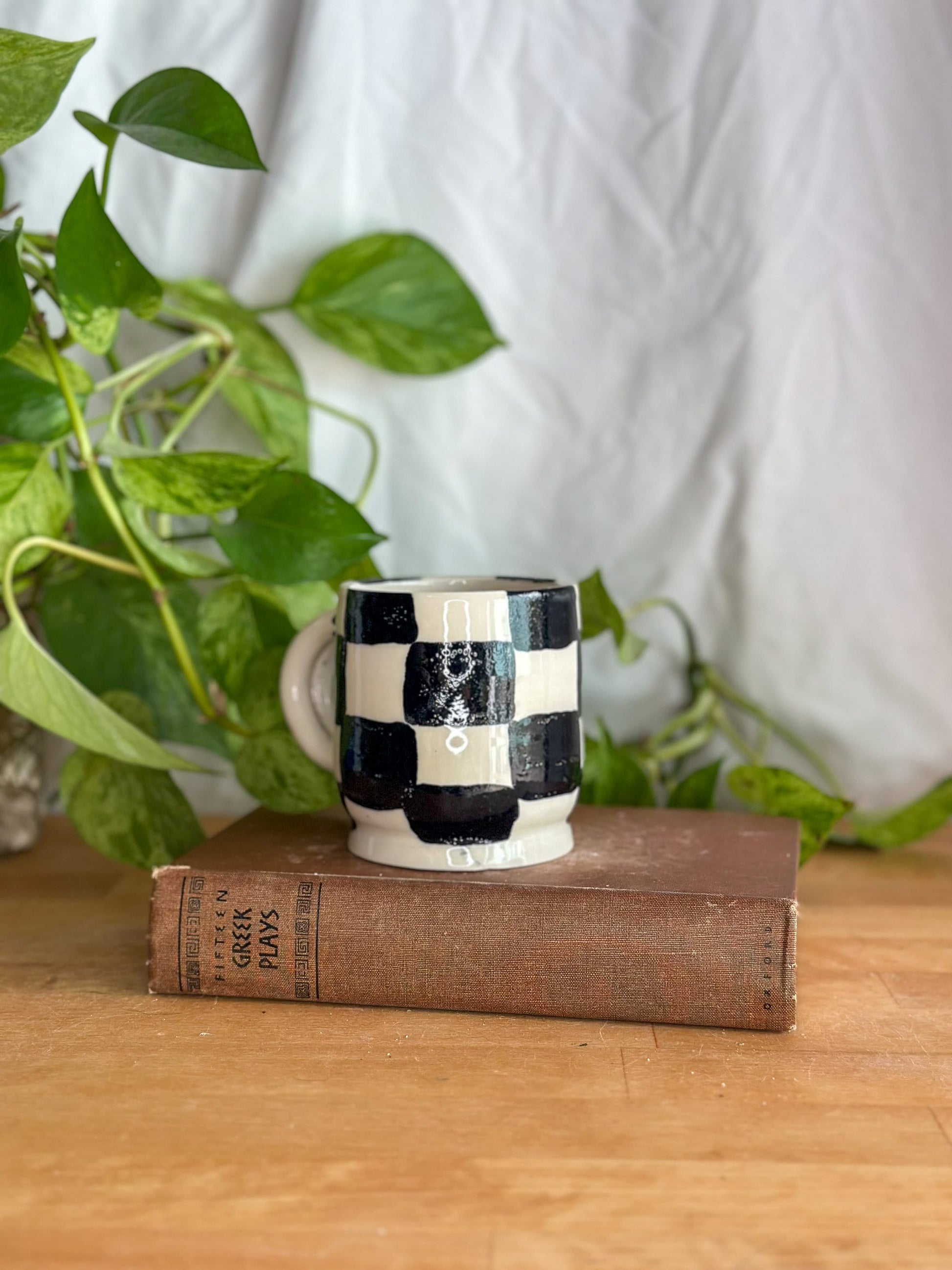 black and white checkered pattern cup