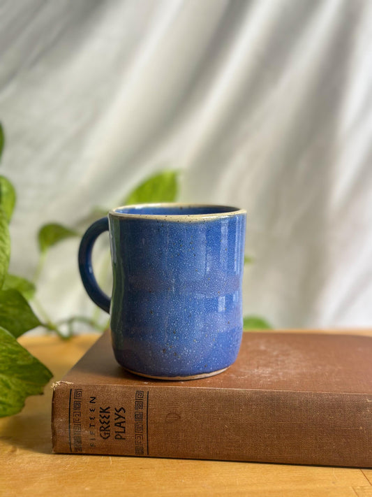 white rimmed blue speckled coffee mug