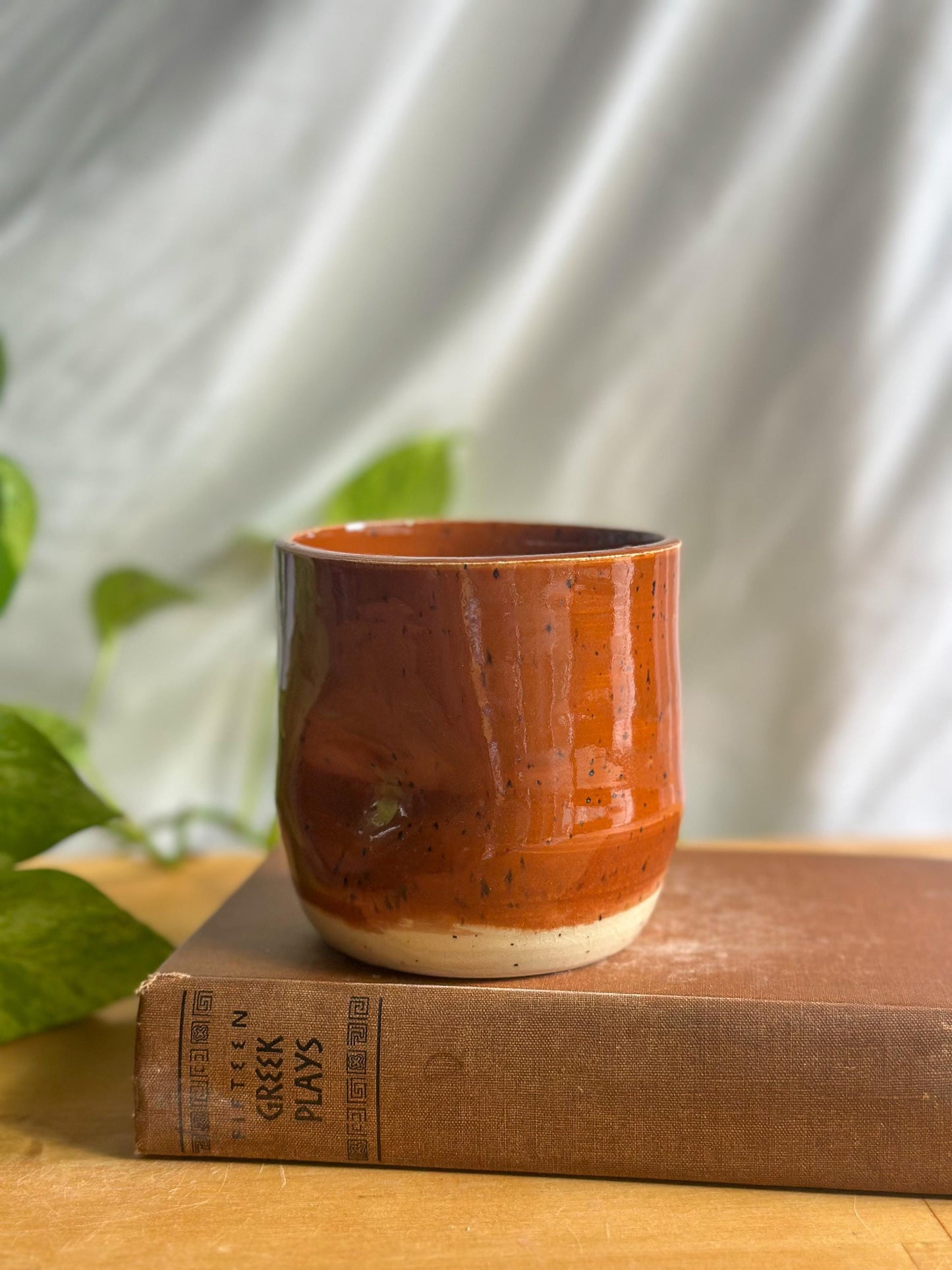 speckled maroon ceramic mug with thumb indent