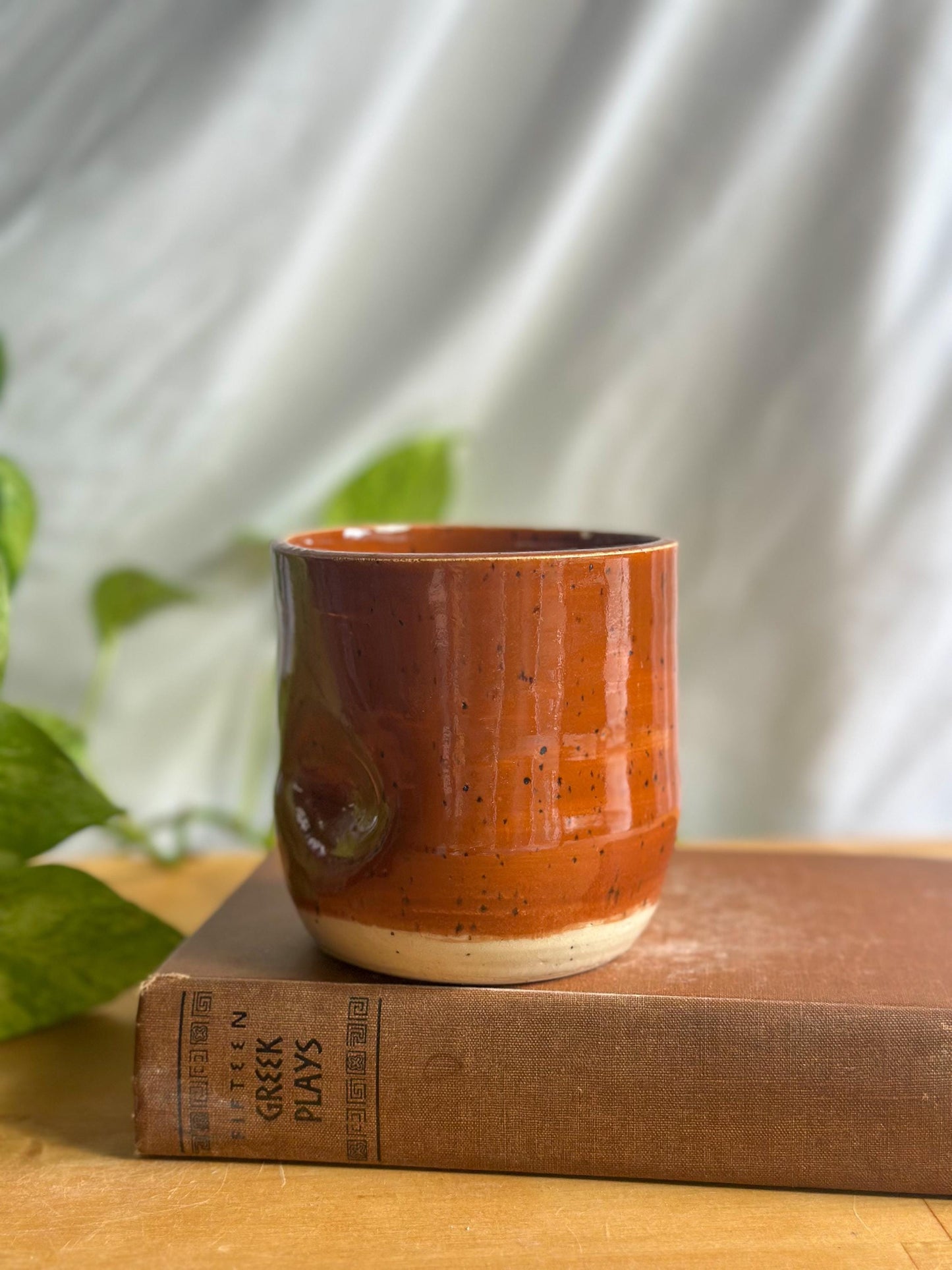 speckled maroon ceramic mug with thumb indent