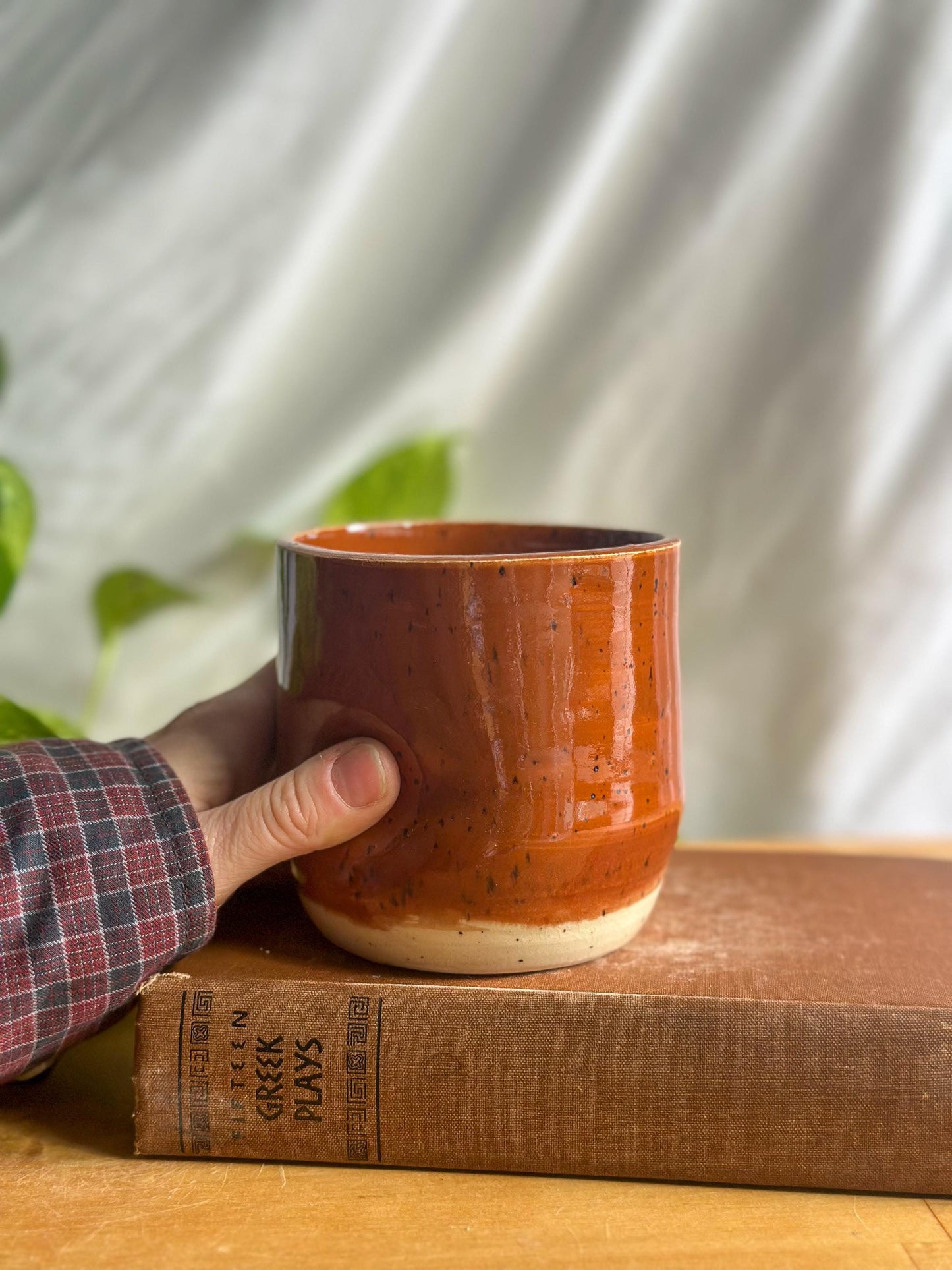 speckled maroon ceramic mug with thumb indent