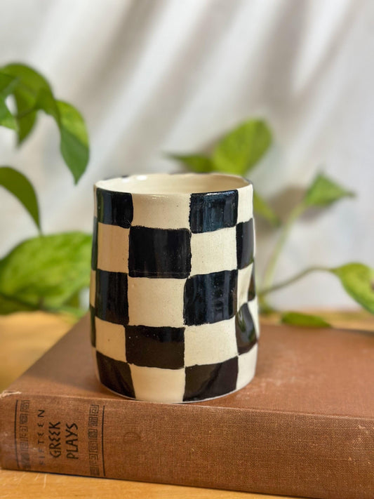 checkered black and white ceramic thumb indent cup