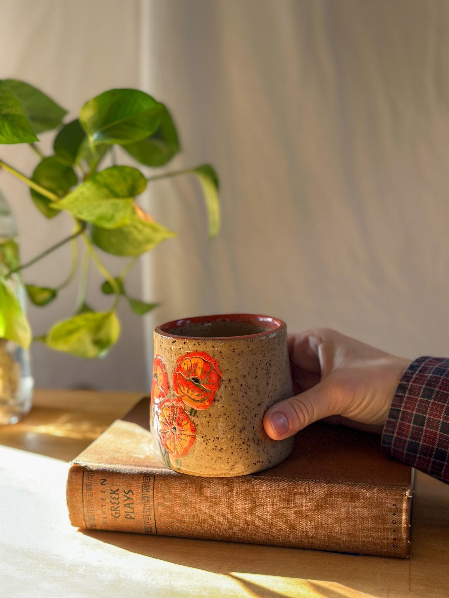 carved poppy flower free palestine ceramic thumb indent mug